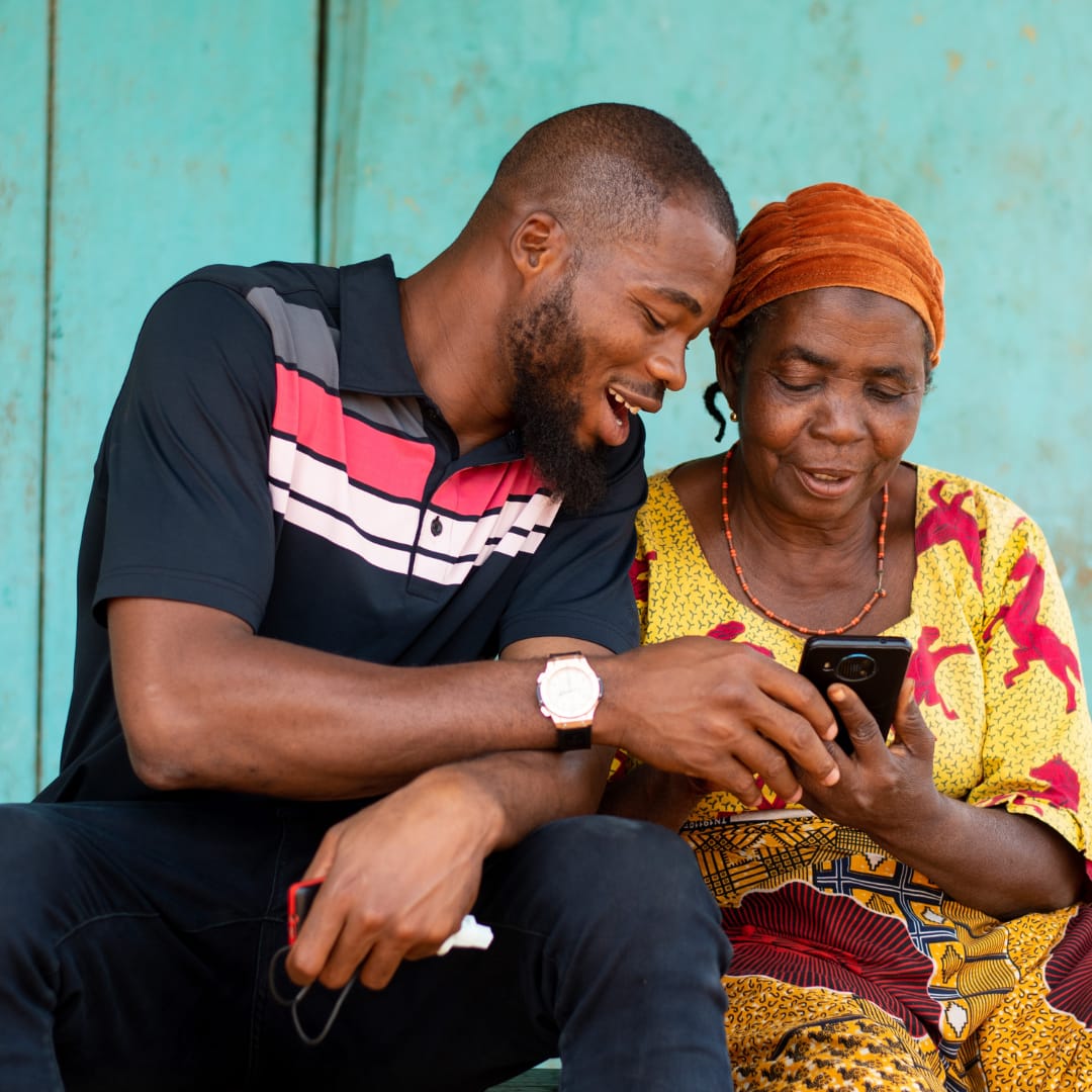 Empowered Women (2) black man showing older black woman holding phone something