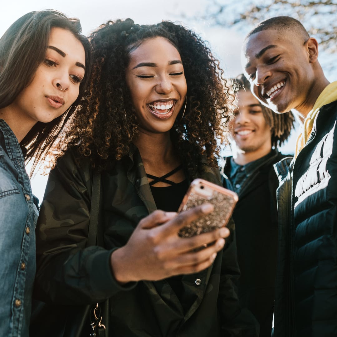 Empowered Women Group of young people looking at something on a phone