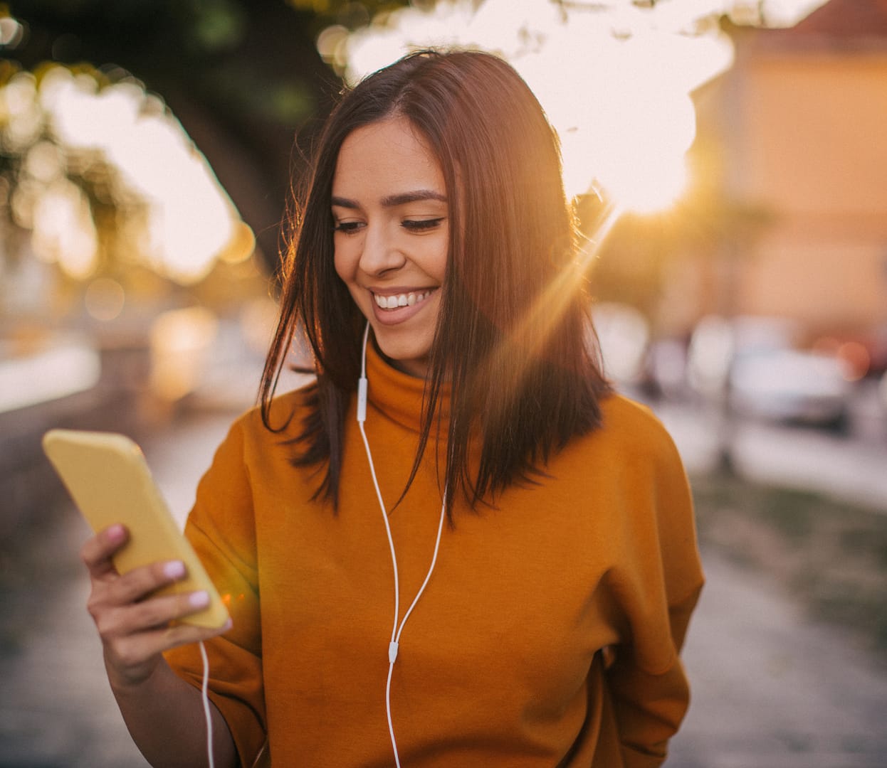 Best Decision (1) Young woman on phone with headphones listening to something.